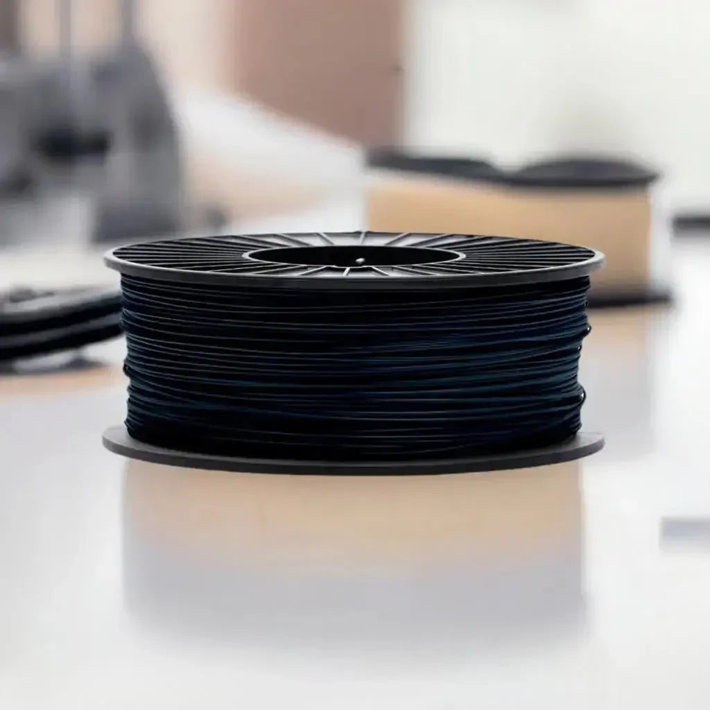 Black 3D printer filament spool on a reflective surface, CoexFlex TPE material