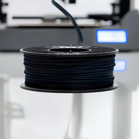 Black TPU 3D printer filament spool on a reflective surface, blurred background