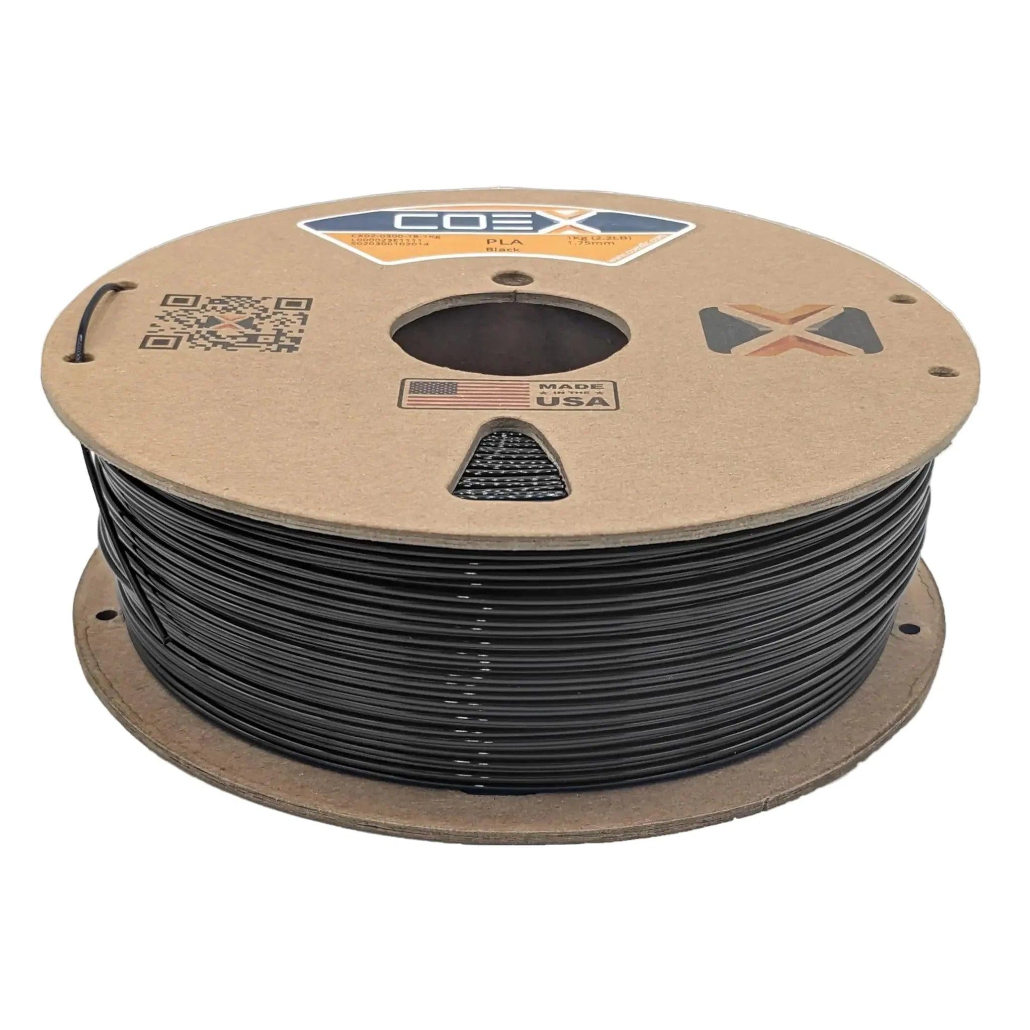 Black PLA 3D printer filament spool labeled COEX, made in USA, on cardboard reel.