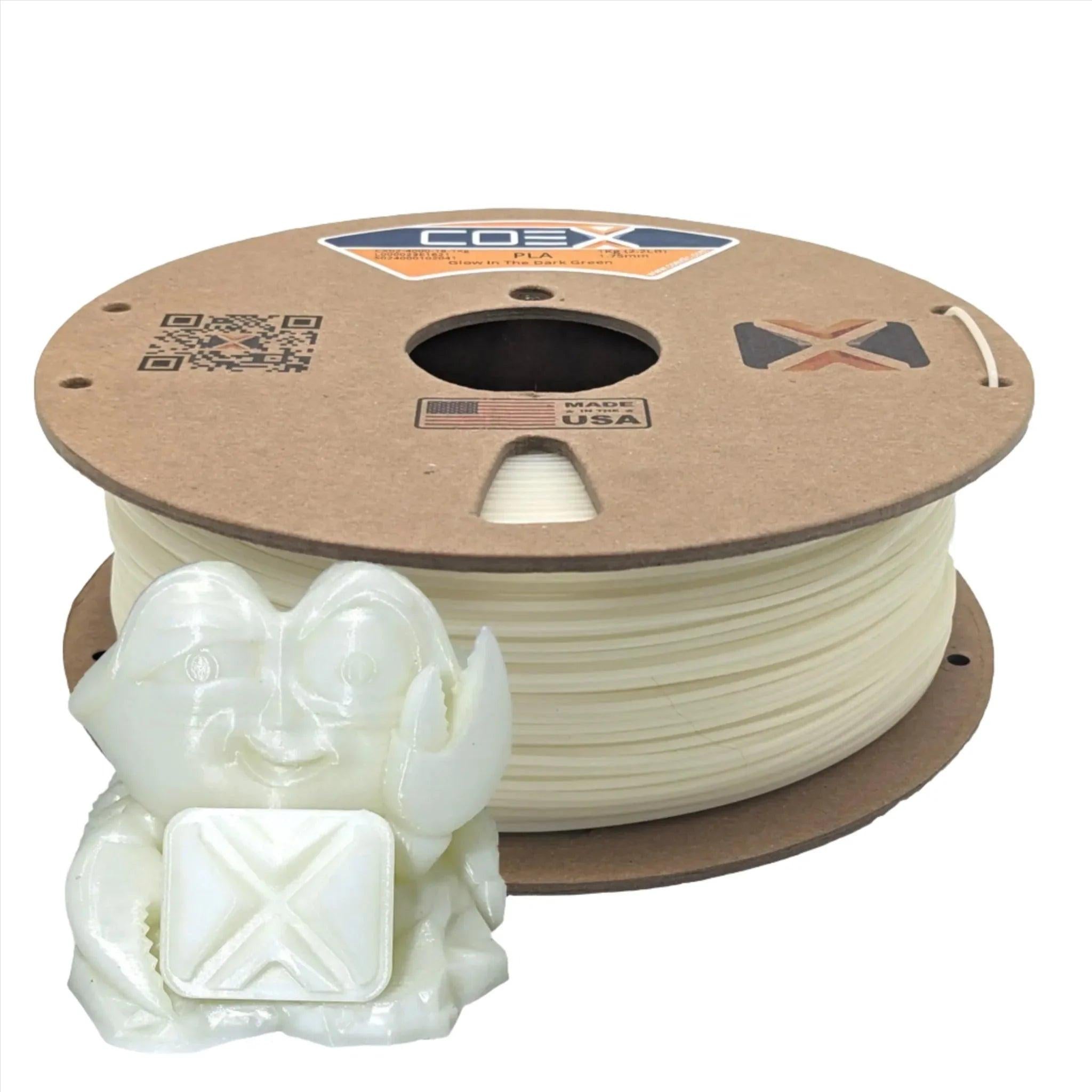 Glow-in-the-dark green PLA 3D printer filament spool with a small printed crab figure