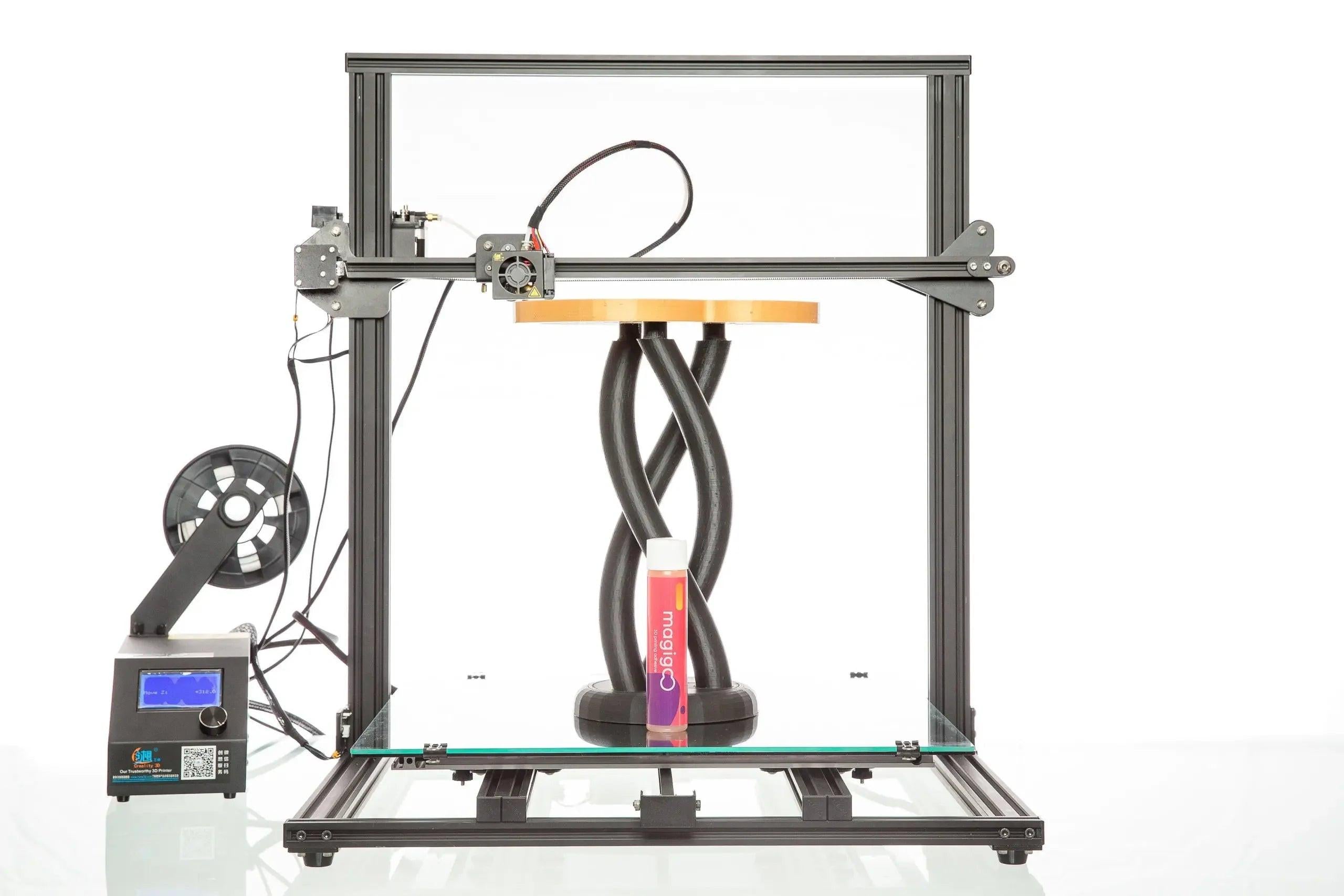 Magigoo Original 120ml 3D printing bed adhesive in front of a 3D printer with filament spool