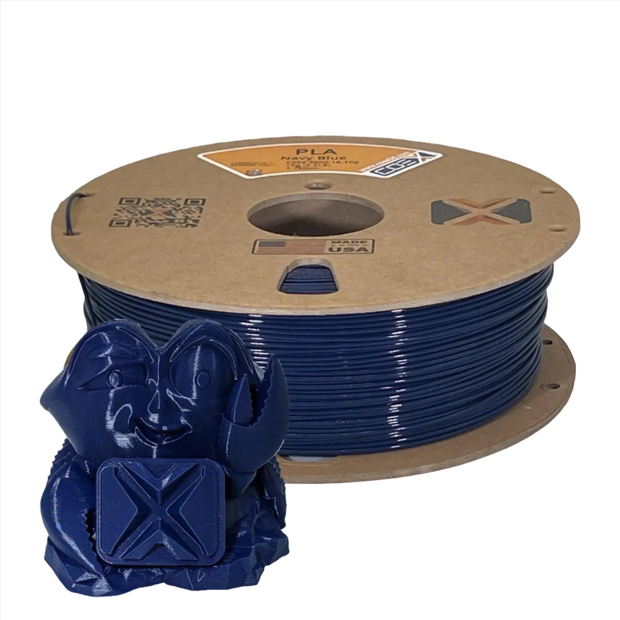 Navy blue PLA 3D printer filament spool with matching 3D printed crab figurine