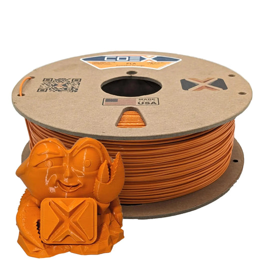 Pumpkin orange COEX 3D PLA filament spool with orange 3D printed crab figure in front
