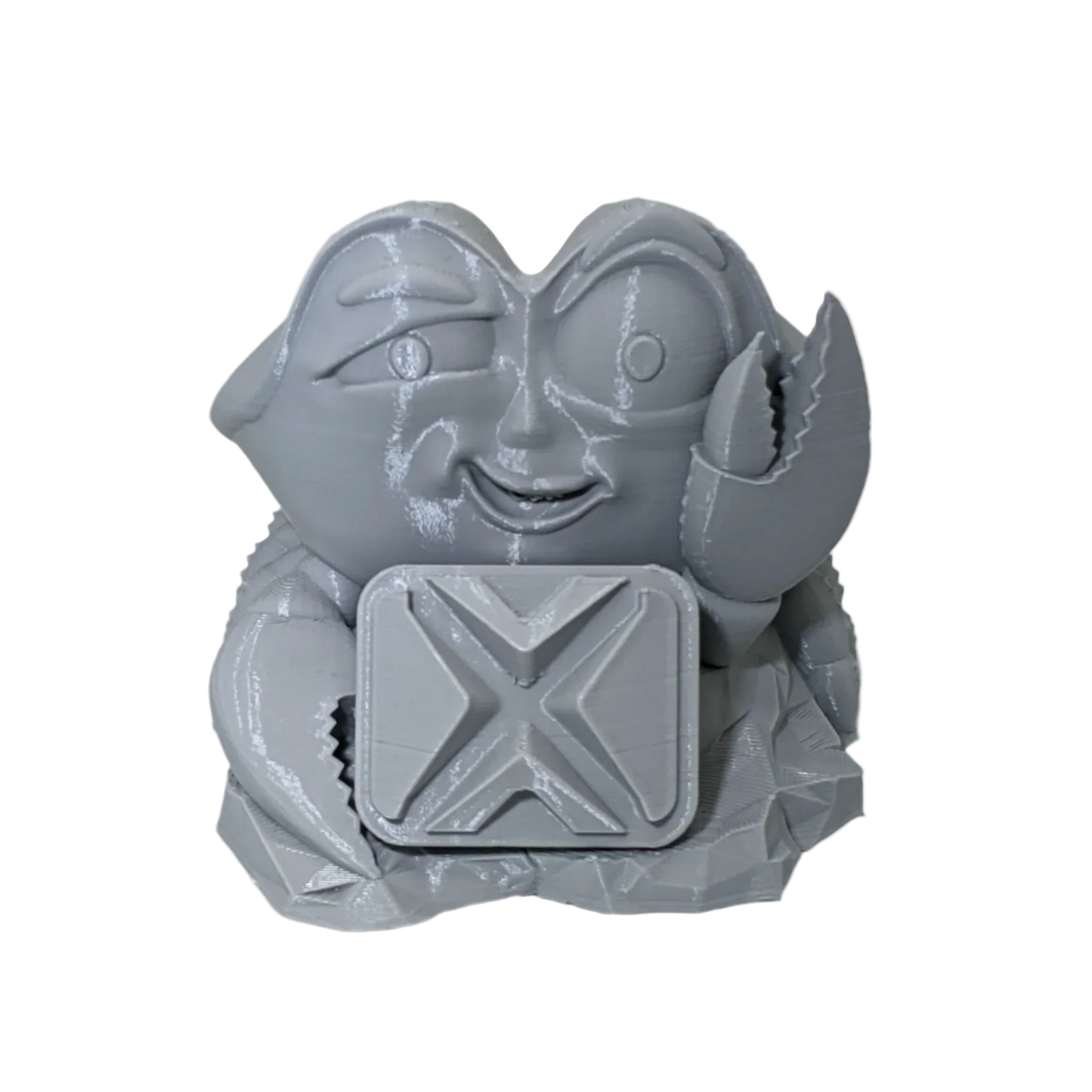 Gray 3D printed crab figurine holding square block with X pattern, isolated on black background