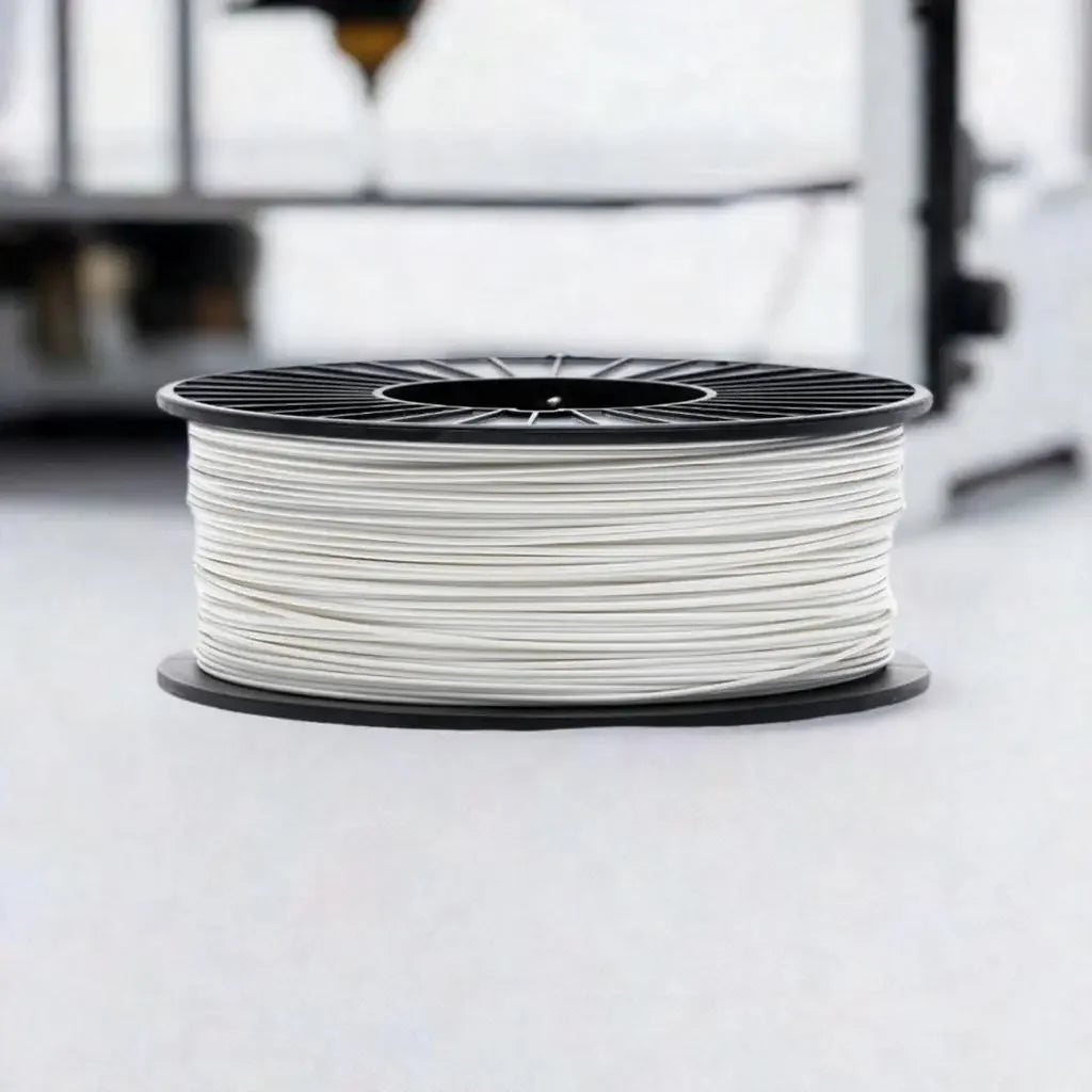 White 3D printer filament spool on black plastic reel, close-up, in modern workspace