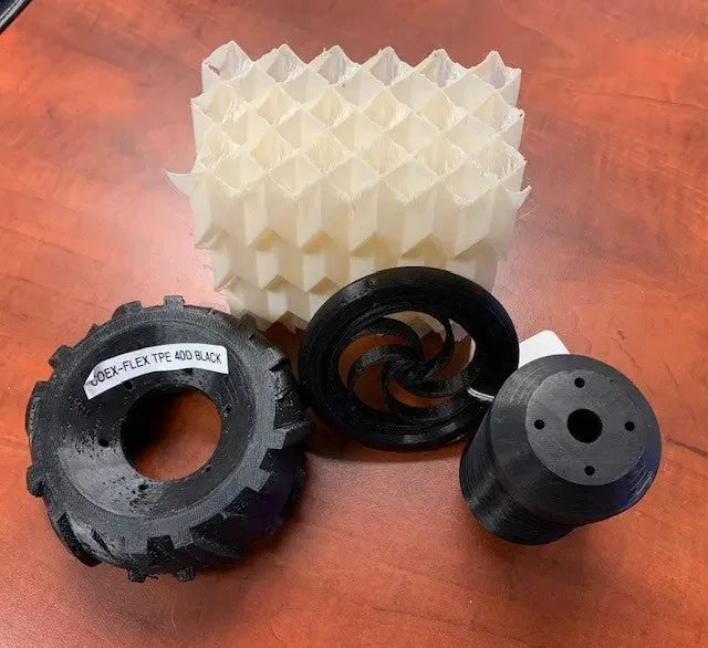 3D printed flexible filament parts and lattice object on a wooden desk