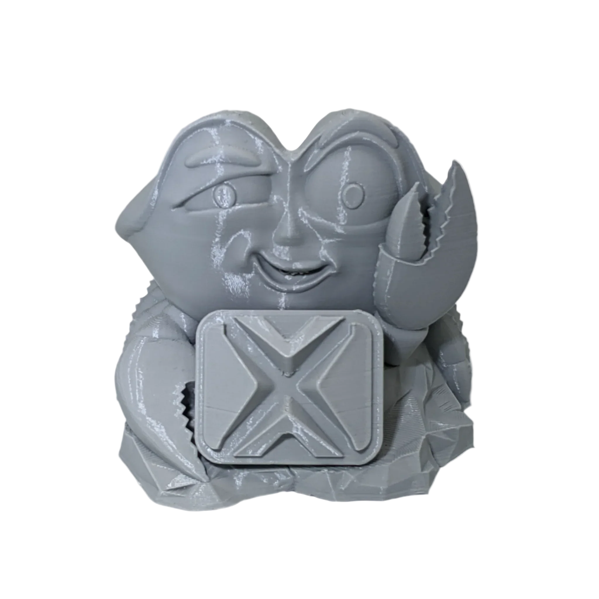 Gray 3D printed crab figurine holding square block with X pattern, isolated on black background