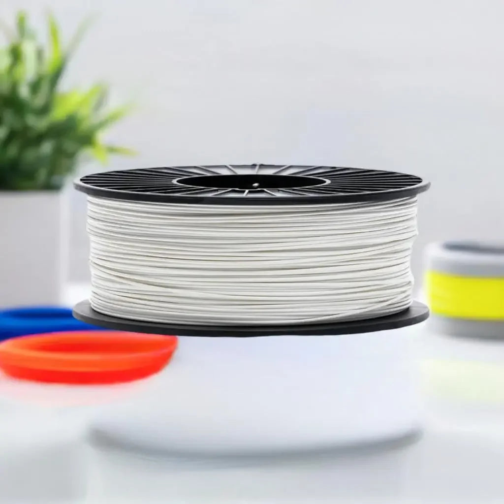 White CoexFlex 60D TPE 3D printer filament spool on table with blurred background
