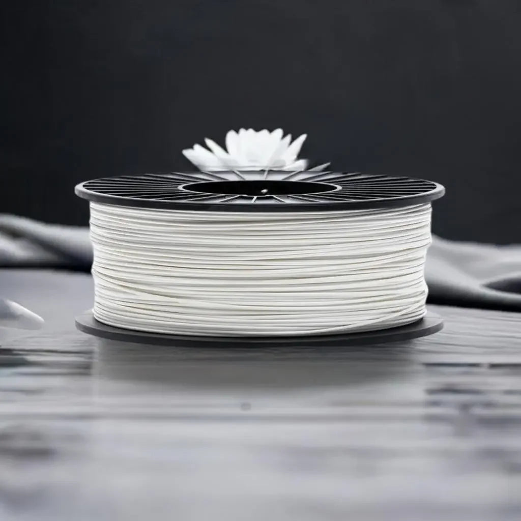 White 3D printer filament spool on a table with a dark background